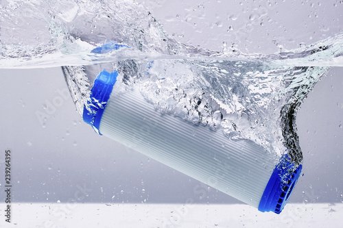 New carbon filter cartridge for house water filtration system isolated on white background. Splash. Concept.