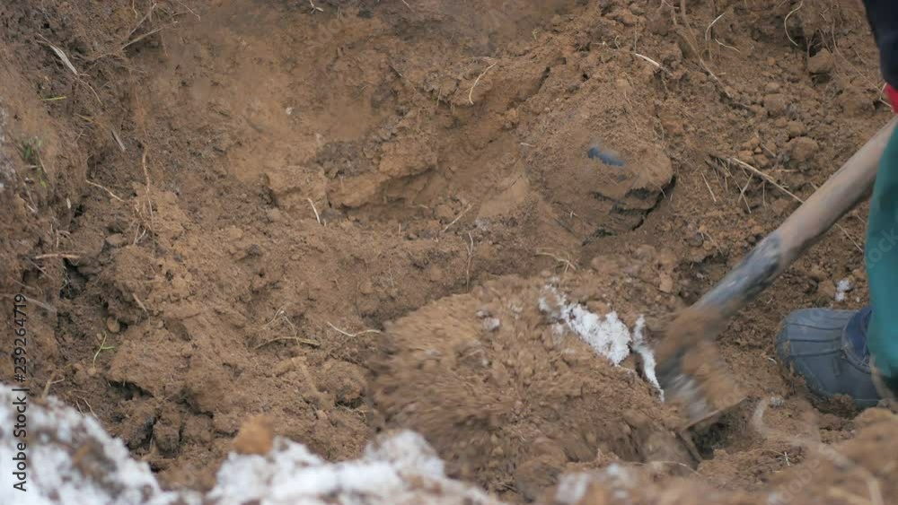 Man digs optic cable connection