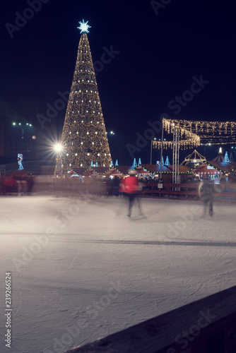 13 DEC 2018, Romania, Bucharest. Ice skating at Christmas Fair in Bucharest Long exposure vertical image. Selective focus.