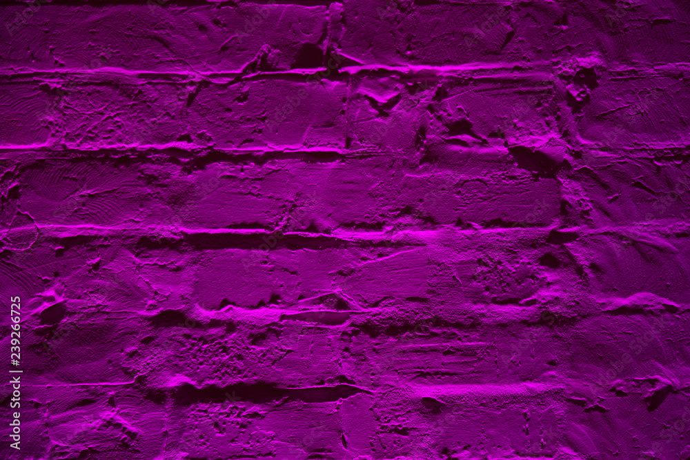 Grunge neon purple brick wall texture background. Magenta colored brick wall texture architexture pattern.