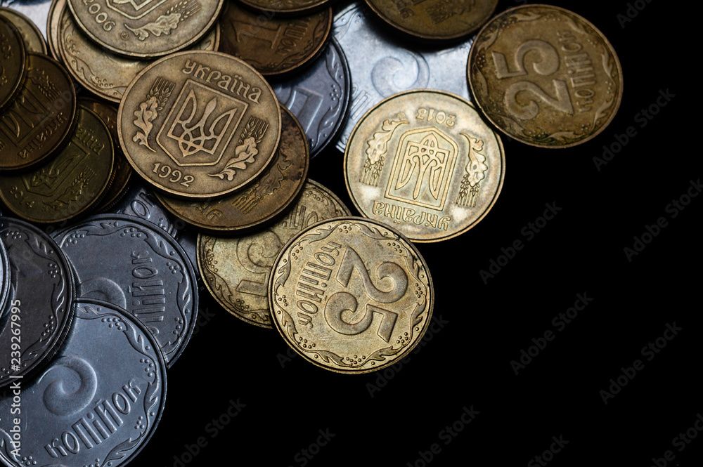 Ukrainian coins isolated on black background. Close-up view. Coins are located at the left side of frame. A conceptual image. Ukrainian coins isolated on black background. Close-up view. Coins are located at the left side of frame. A conceptual image.