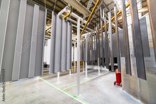 Powder coating line. Metal panels are suspended on an overhead conveyor line. photo