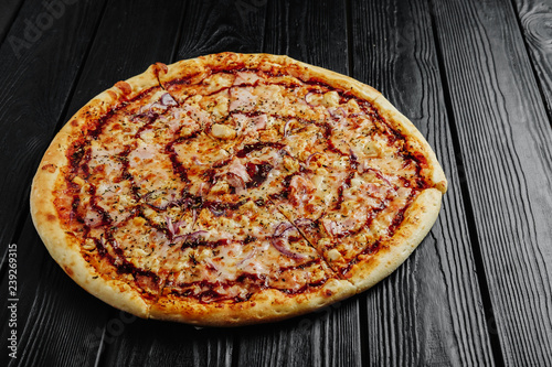 pizza barbecue sauce with chicken on black wooden background top view