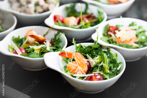 Tasty salad plates with shrimps. Close up image with selective focus.