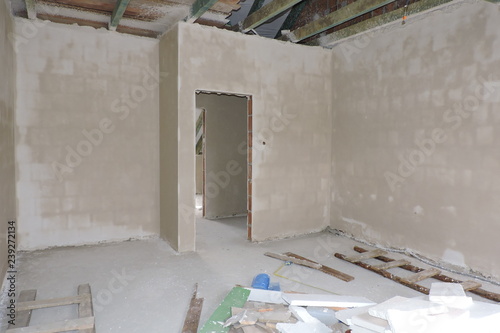 Walls of an empty room under construction covered with hard plaster