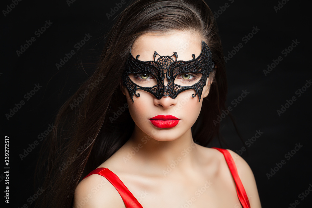 Perfect sexy woman in carnival mask on black background with abstract night glitter bokeh