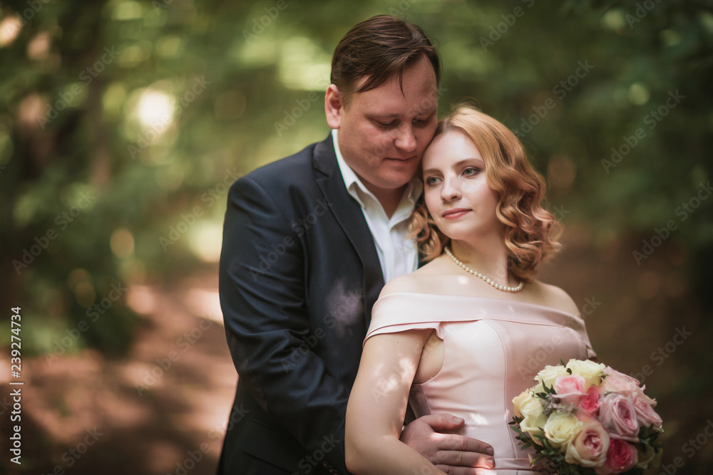 bride and groom dancing in the forest background and sunlight