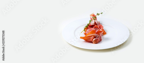  Parma Ham on a white plate on a white background isolated