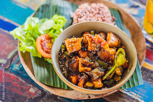 Popular Balinese meal of rice with variety of side dishes which are served together with the rice and more as optional extras photo