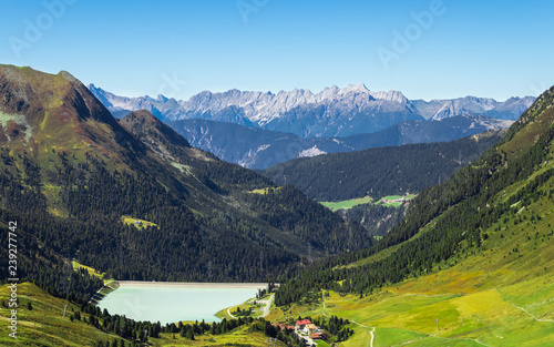 Amazing colorful view of the Alpine dam Speicher Längental with high mountains in the background over Kuhtai in Tirol, Austria