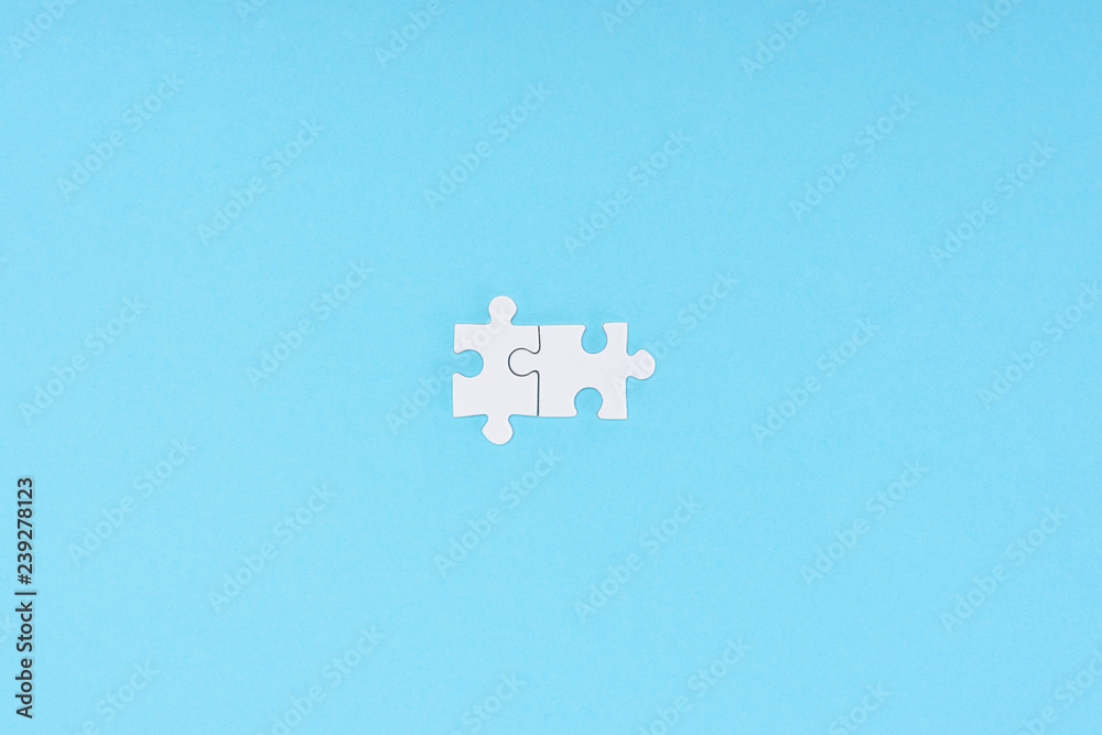top view of white puzzle pieces arranged on blue backdrop top view of white puzzle pieces arranged on blue backdrop
