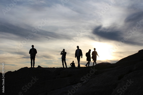 silhouette of people on top of mountain