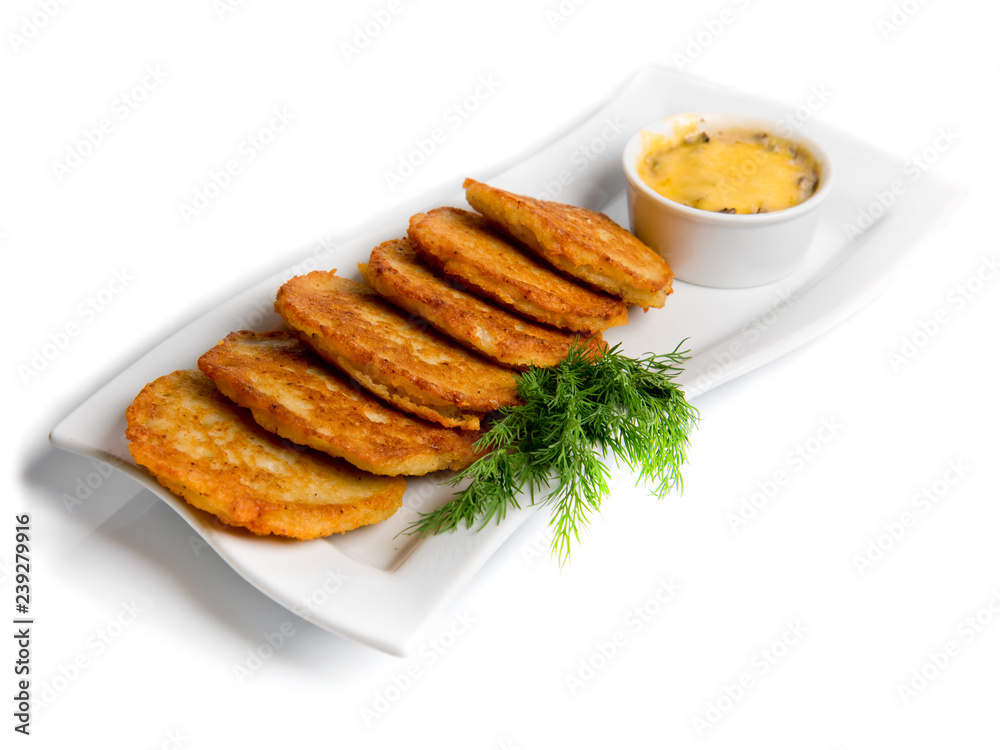 Pan-fried potato pancakes traditional potato fritters on a plate isolated on white background. Pan-fried potato pancakes traditional potato fritters on a plate isolated on white background.