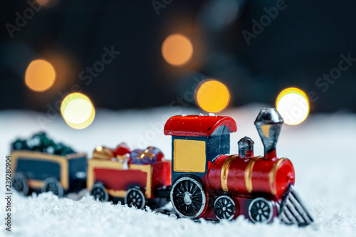 The Christmas train in the snow on bokeh background