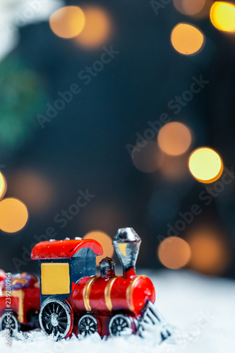 The Christmas train in the snow on bokeh background