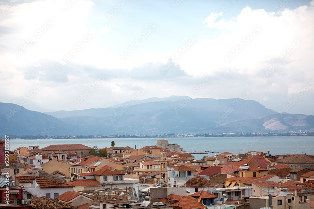 Panoramic view on Bourtzi castle and Nafplion from the fortress of Palamidi, Greece - Immagine. Roof and surrounding views of Greek city Nafplio, from Peloponnese region