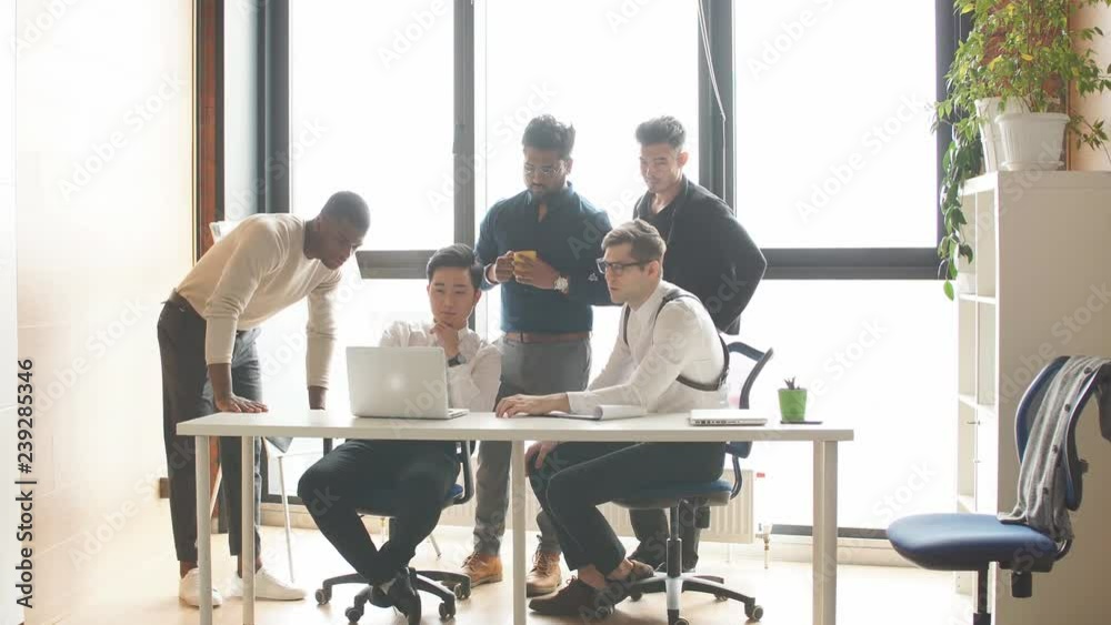 Multiethnic corporate business team reporting the Head of department about the results of done work, gathering in spacy and airy conference room in office