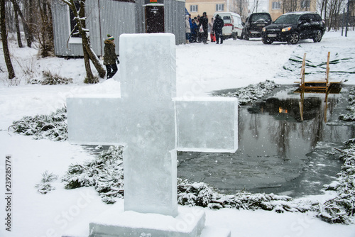 A cross in front of a ice-hole. In the ice vyrabany cross. Hole in the form of a cross. Before the bathing rite. Religious feast of Epiphany. Ukraine. Belogorodka. January 18, 2018