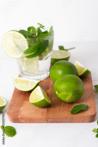 mojito with lime and mint on a wooden board.