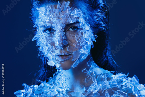 Fototapeta Naklejka Na Ścianę i Meble -  Female face covered with a lot small pieces of glass or ice