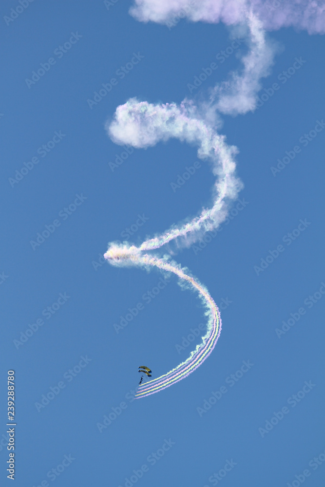 Parachutist with spiral clouds of smoke over San Diego, California Parachutist with spiral clouds of smoke over San Diego, California