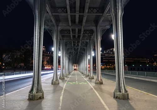 Metal columns and abutments of Pont de Bir-Hakeim at night, also known as viaduc de Passy - Paris, France