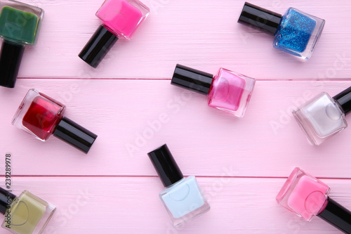 Fototapeta Naklejka Na Ścianę i Meble -  Group of bright nail polishes on pink background