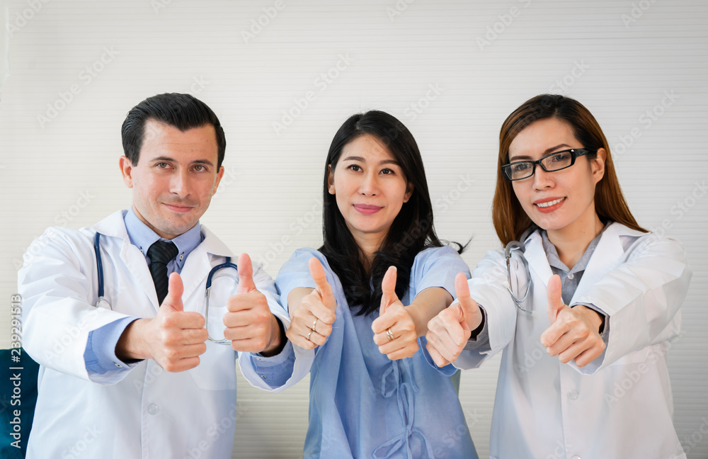 Team of doctor and patient smiling giving thump up in Hospital. Team of doctor and patient smiling giving thump up in Hospital.