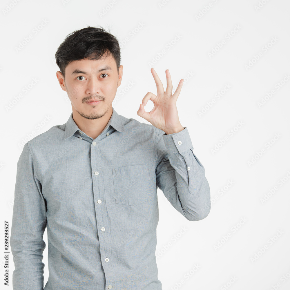 Fototapeta premium Young man makes okay hand sign.