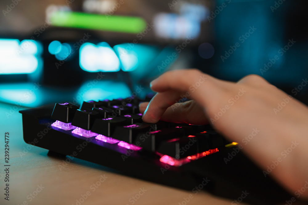 Close up of a women's hand typing on a gamer Close up of a women's hand typing on a gamer