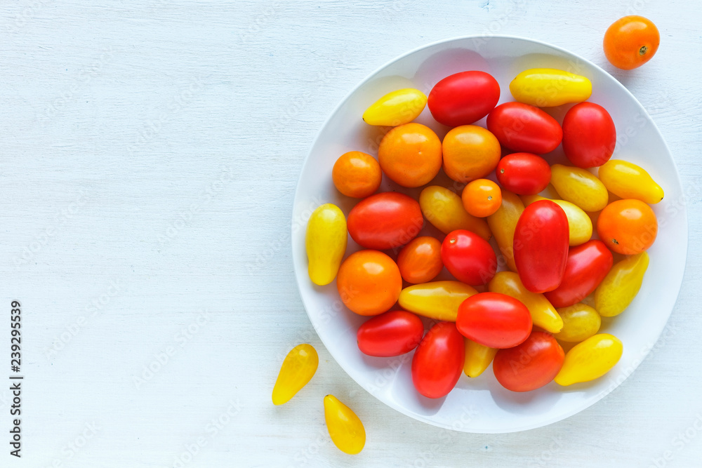 Plate with yellow and red tomatoes Plate with yellow and red tomatoes