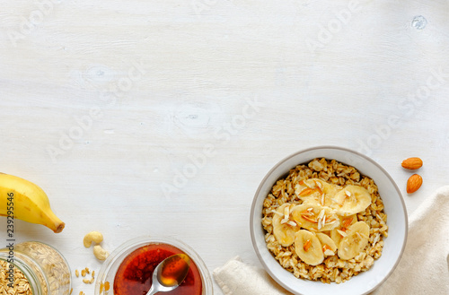 Bowl of oatmeal with banana slieces photo