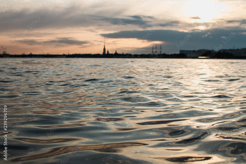 Sunset light being reflected on water of Neva river in the evening in Saint Petersburg, Russia - Image