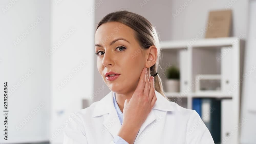 medicine, healthcare and technology concept - female doctor participating in video call or consultation and showing tonsils at hospital medicine, healthcare and technology concept - female doctor participating in video call or consultation and showing tonsils at hospital