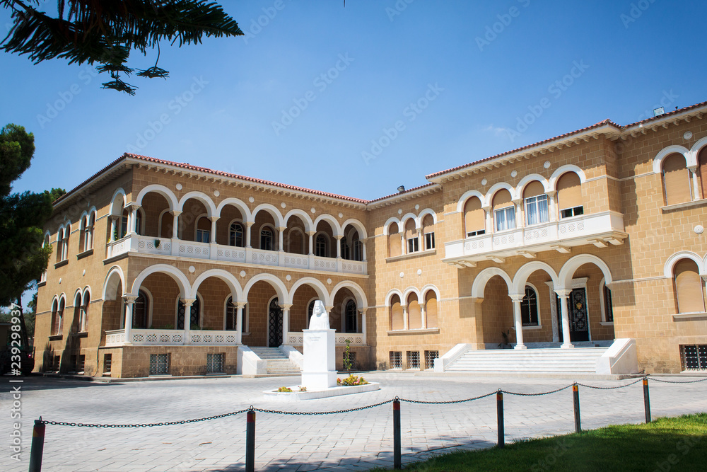 Archbishop's famous palace in Cyprus - a three-story building made in neo-Byzantine style. The decoration is high arches, elegant stucco and large windows. Nearby is the bronze statue of Makarios III