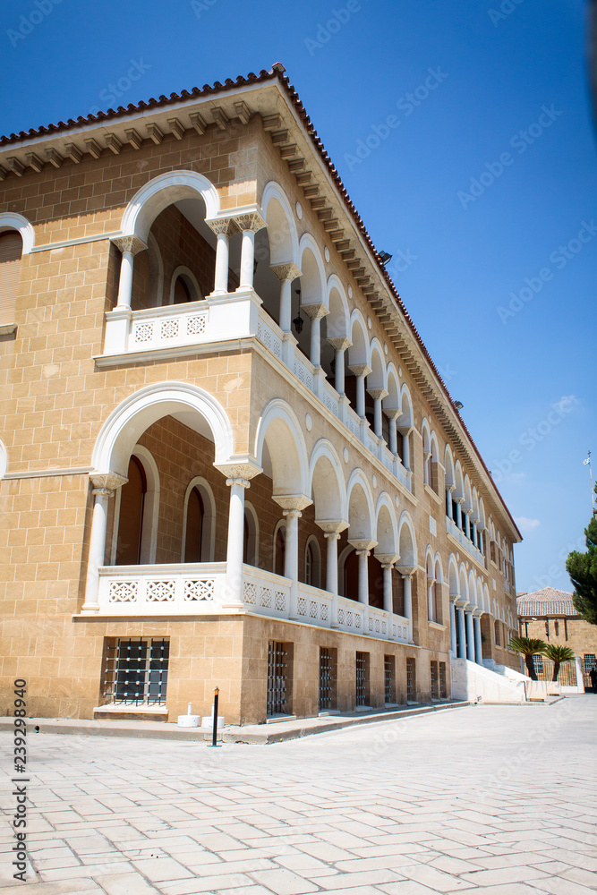 Archbishop's famous palace in Cyprus - a three-story building made in neo-Byzantine style. The decoration is high arches, elegant stucco and large windows. Nearby is the bronze statue of Makarios III