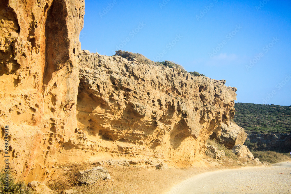 Large high rocks on the way to the reserved sandy beach of Lara on the island of Cyprus