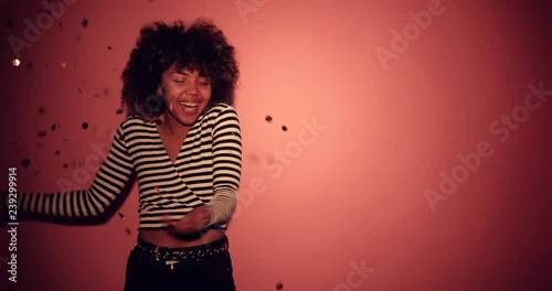 Pretty African Black girl with curly hair dance her favorite song on pantone background. 4K Footage - Video