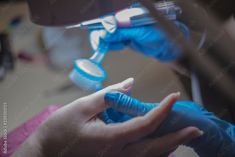 Manicure process, cleaning of nails by a milling cutter.