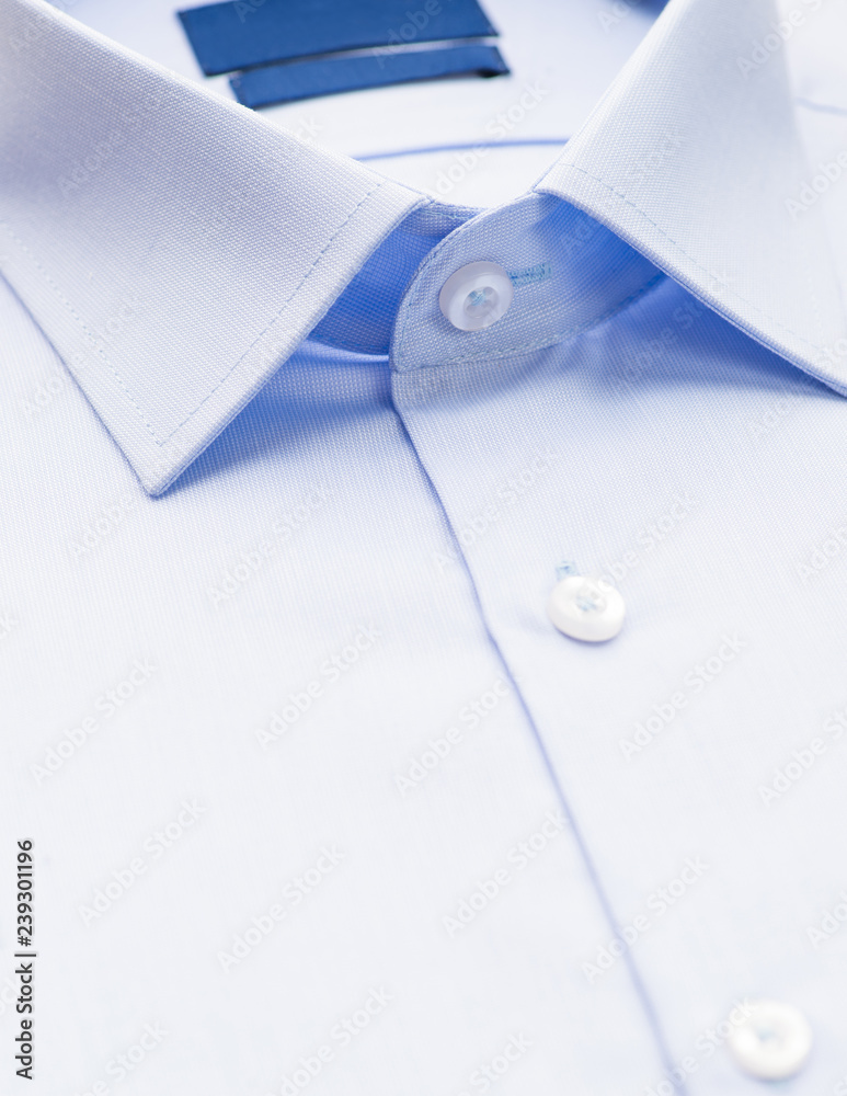 light blue shirt with a focus on the collar and button, close-up light blue shirt with a focus on the collar and button, close-up