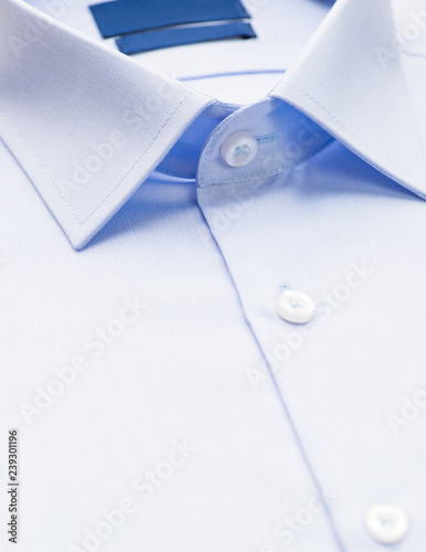 light blue shirt with a focus on the collar and button, close-up