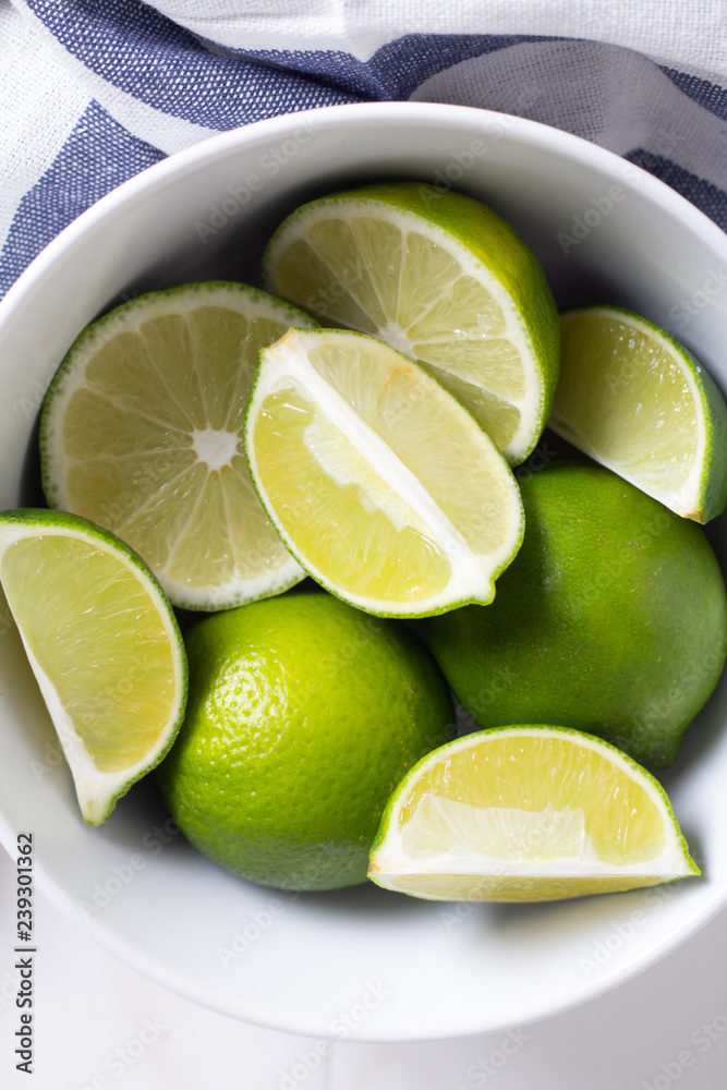 lime in white plate close up top view. lime in white plate close up top view.