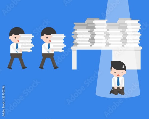 Businessman kneeling in front of table with work overload