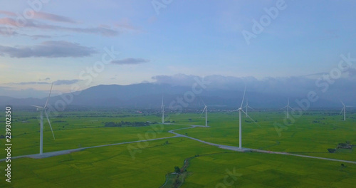 Wind turbine farm and agricultural fields on blue sky. Turbine green energy electricity or wind turbine in a green field - Energy Production with clean and Renewable Energy. Phan Rang  Vietnam