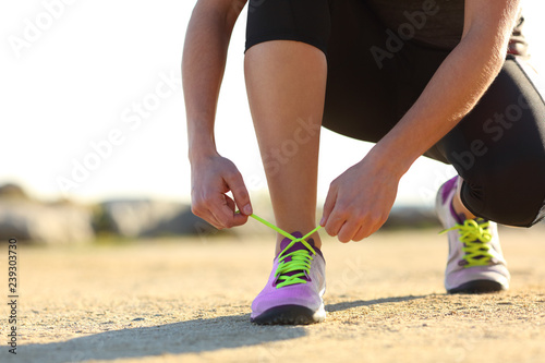 Runner tying shoe laces outdoors