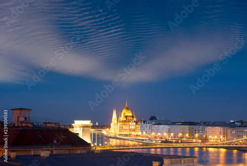 Illuminated Hungarian Parliament building in city environment
