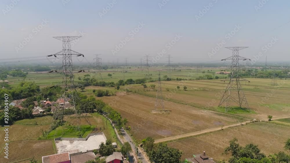 Electricity pylons bearing power supply across agricultural land with ...