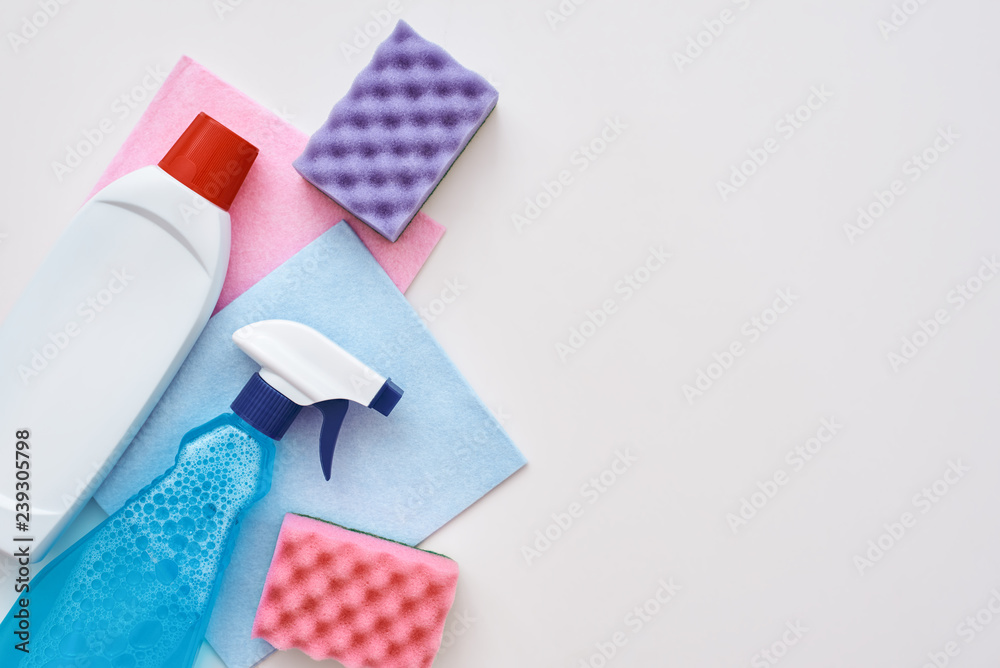 Cleaning tools. Spray bottle and other items isolated at the left corner Cleaning tools. Spray bottle and other items isolated at the left corner