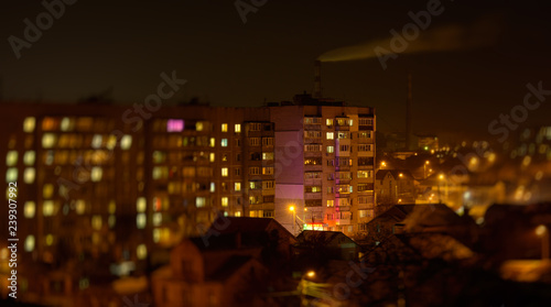 Wallpaper Mural Photo of buildings at night with factory smoke above them Torontodigital.ca
