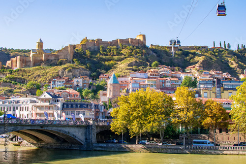 View at Metehi bridge, Narikala fortress and Tbilisi old town. Georgia, famous tourist places.
